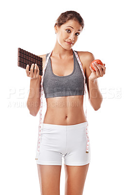 Buy stock photo Woman, chocolate and apple with choice and measuring tape for diet, weight loss and balance snacks on white background. Nutrition, fruit and candy with unhealthy versus healthy food for benefits