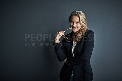 Buy stock photo Studio portrait of a mature businesswoman posing against a grey background