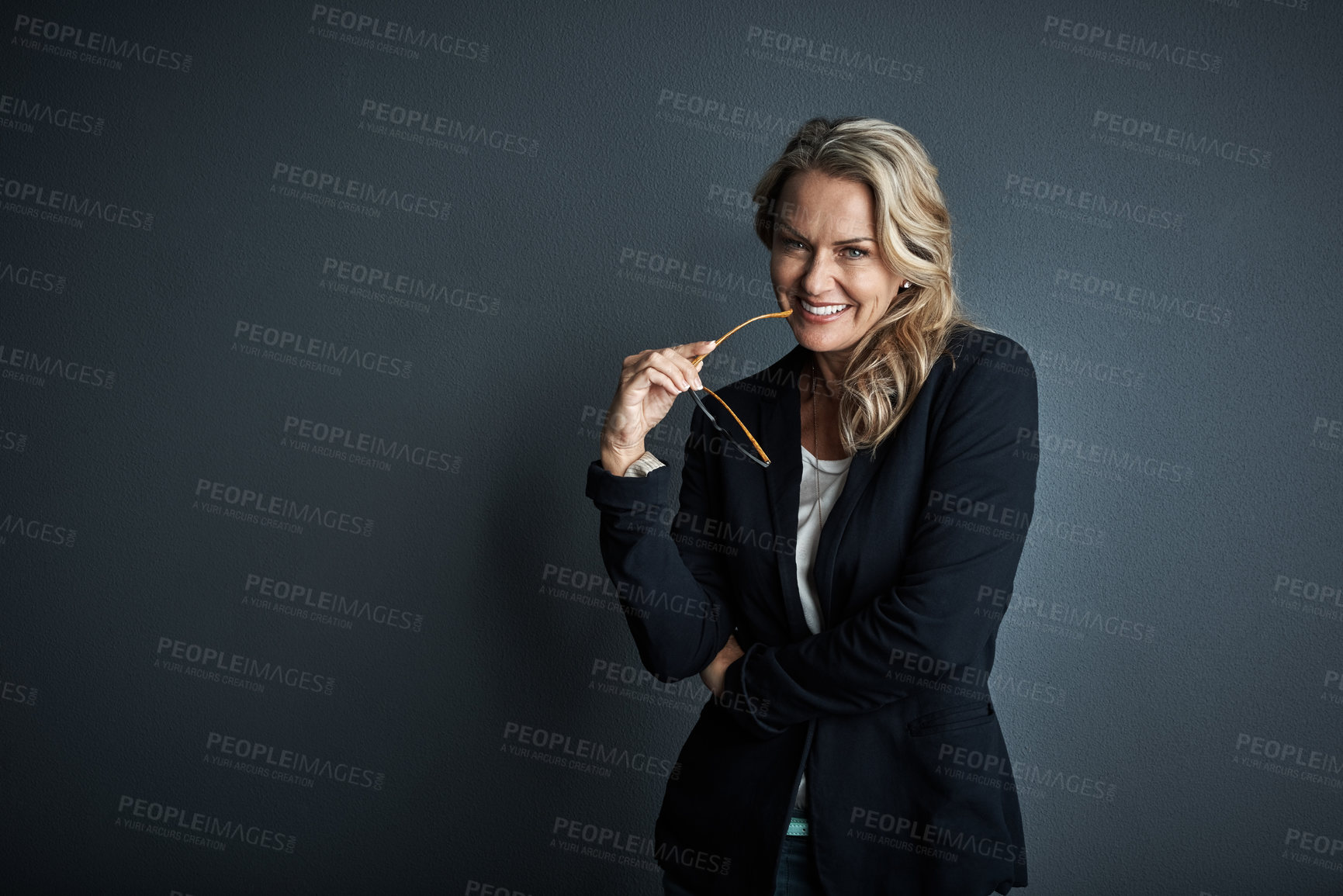 Buy stock photo Studio portrait of a mature businesswoman posing against a grey background