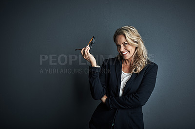 Buy stock photo Studio portrait of a mature businesswoman posing against a grey background