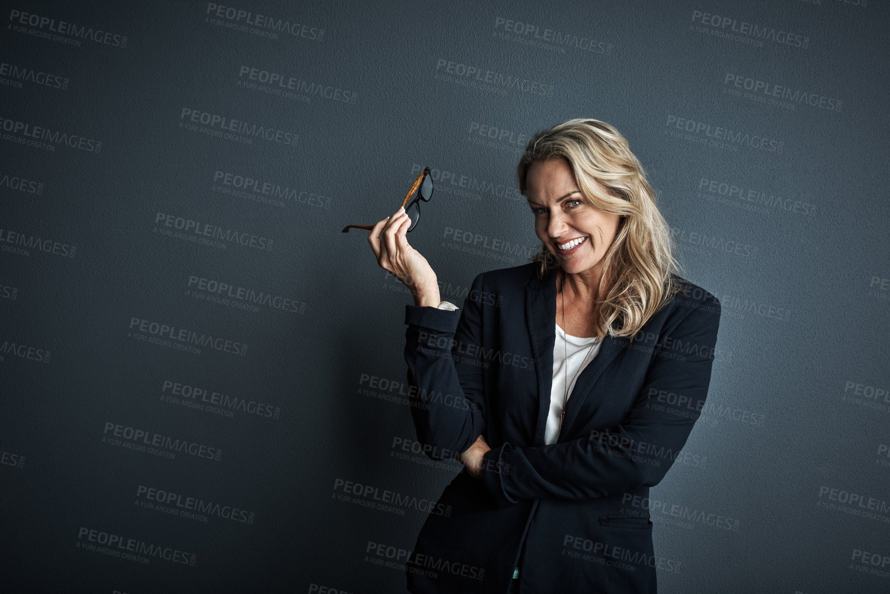 Buy stock photo Studio portrait of a mature businesswoman posing against a grey background