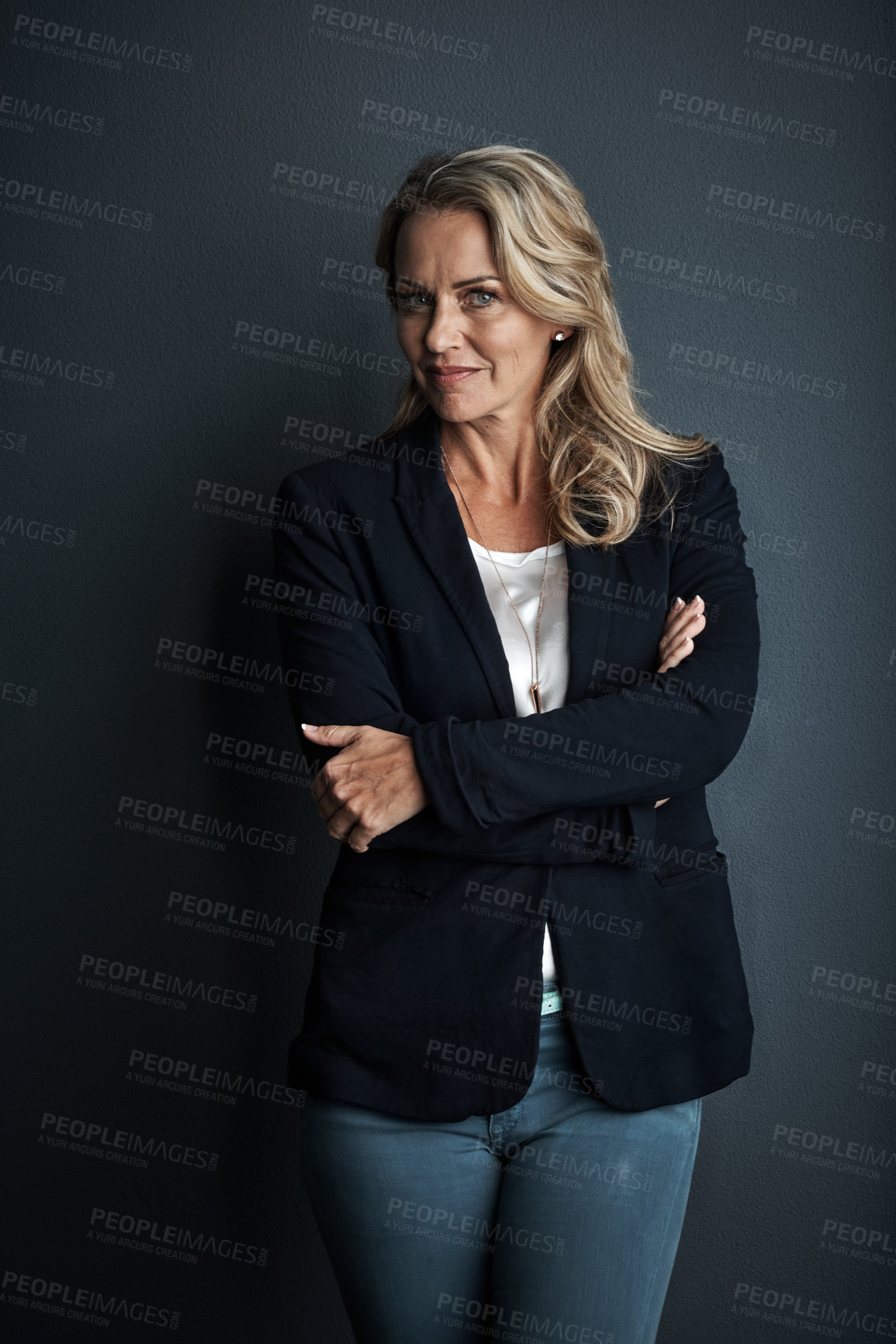 Buy stock photo Studio portrait of a mature businesswoman posing against a grey background