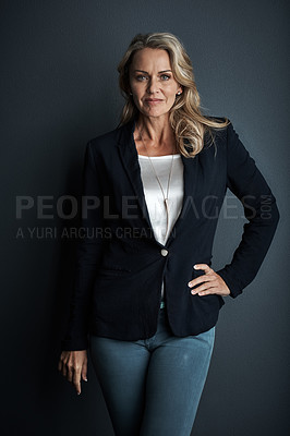 Buy stock photo Studio portrait of a mature businesswoman posing against a grey background