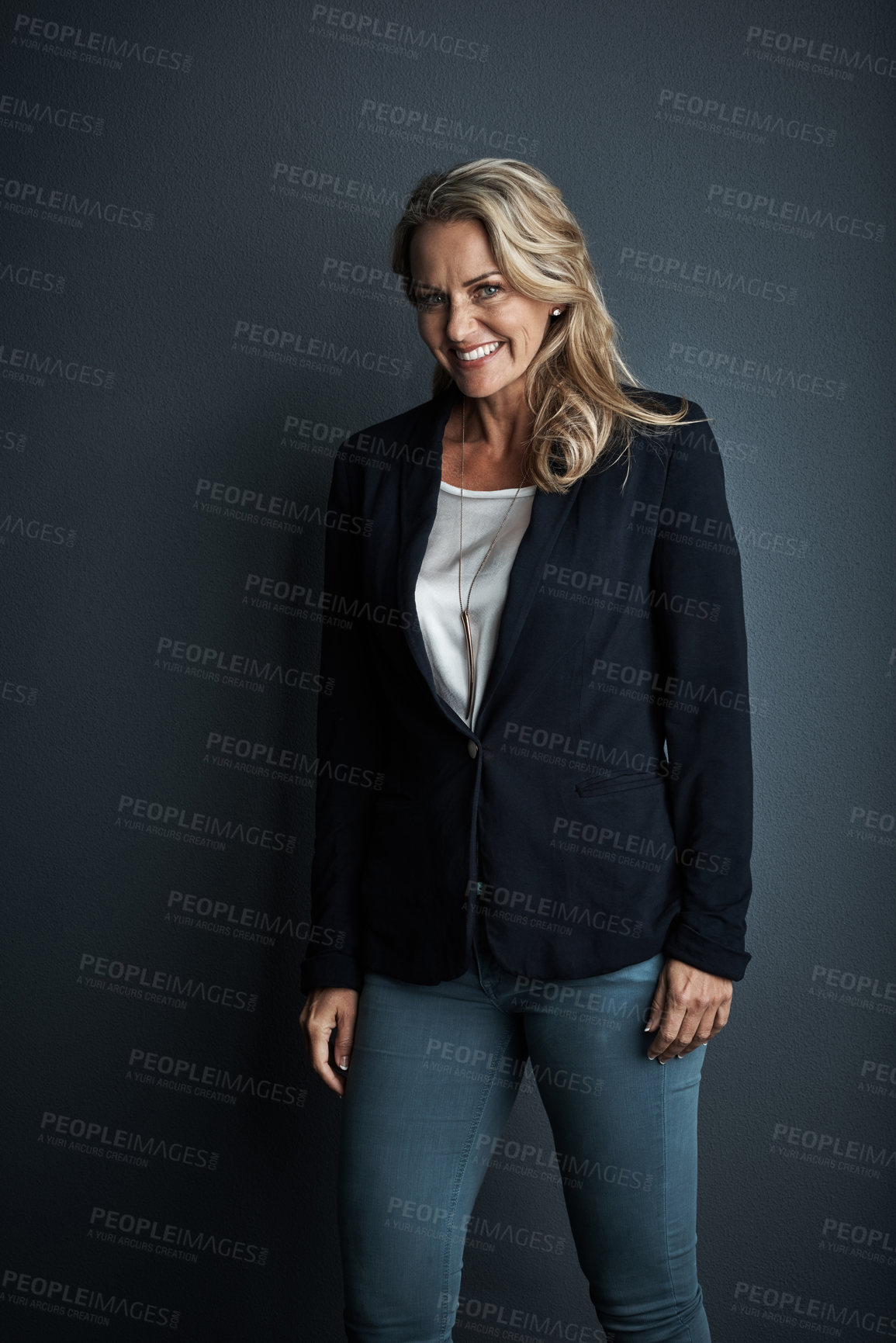 Buy stock photo Studio portrait of a mature businesswoman posing against a grey background