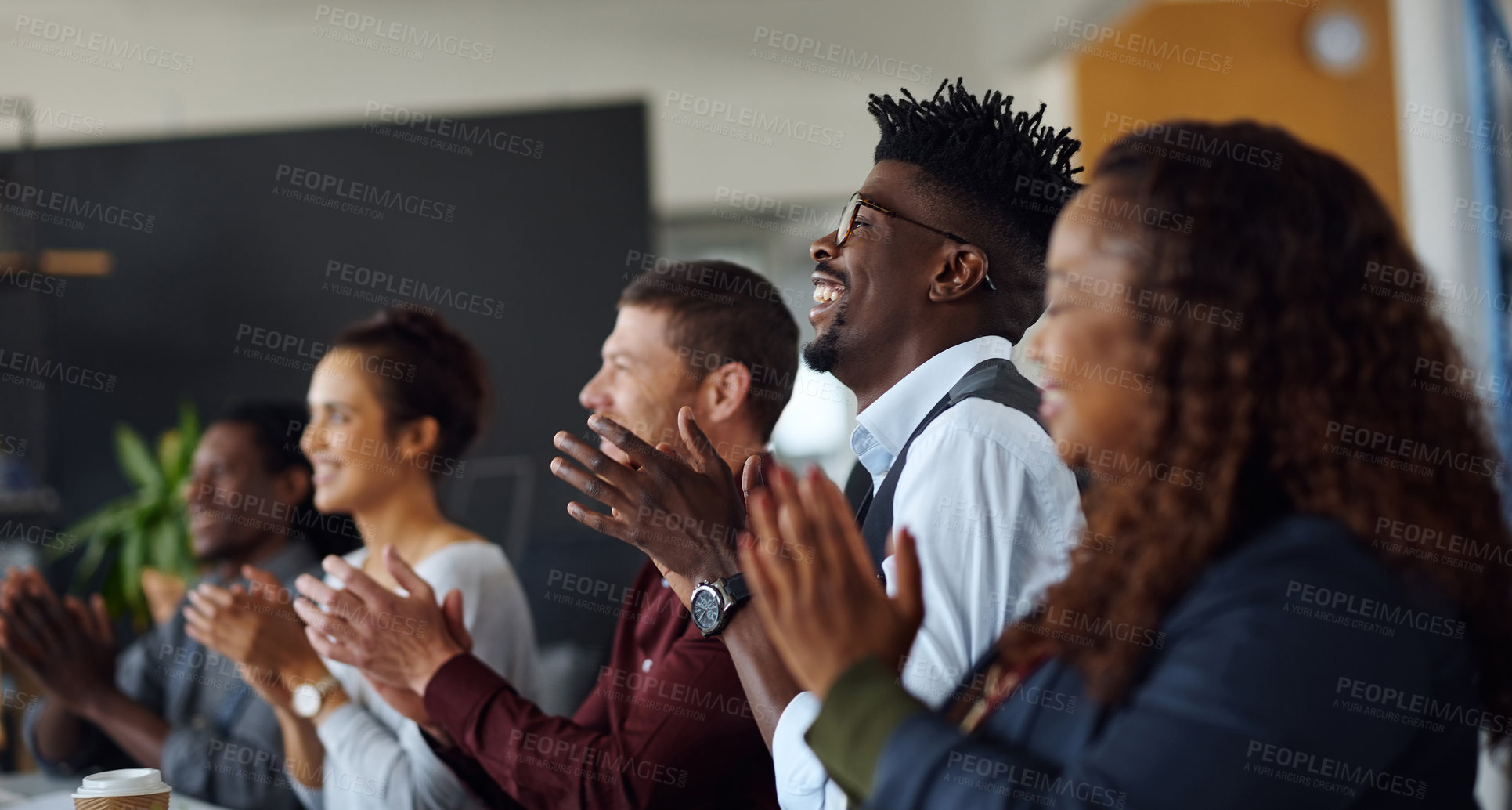 Buy stock photo Shot of a group of businesspeople applauding during a presentation in an office