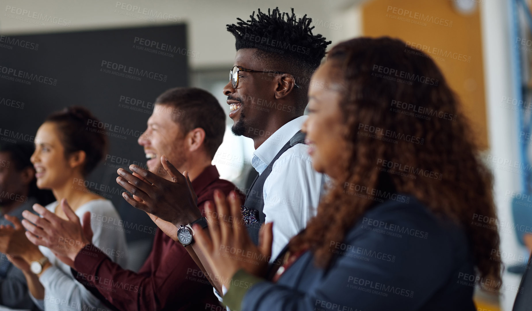 Buy stock photo Shot of a group of businesspeople applauding during a presentation in an office