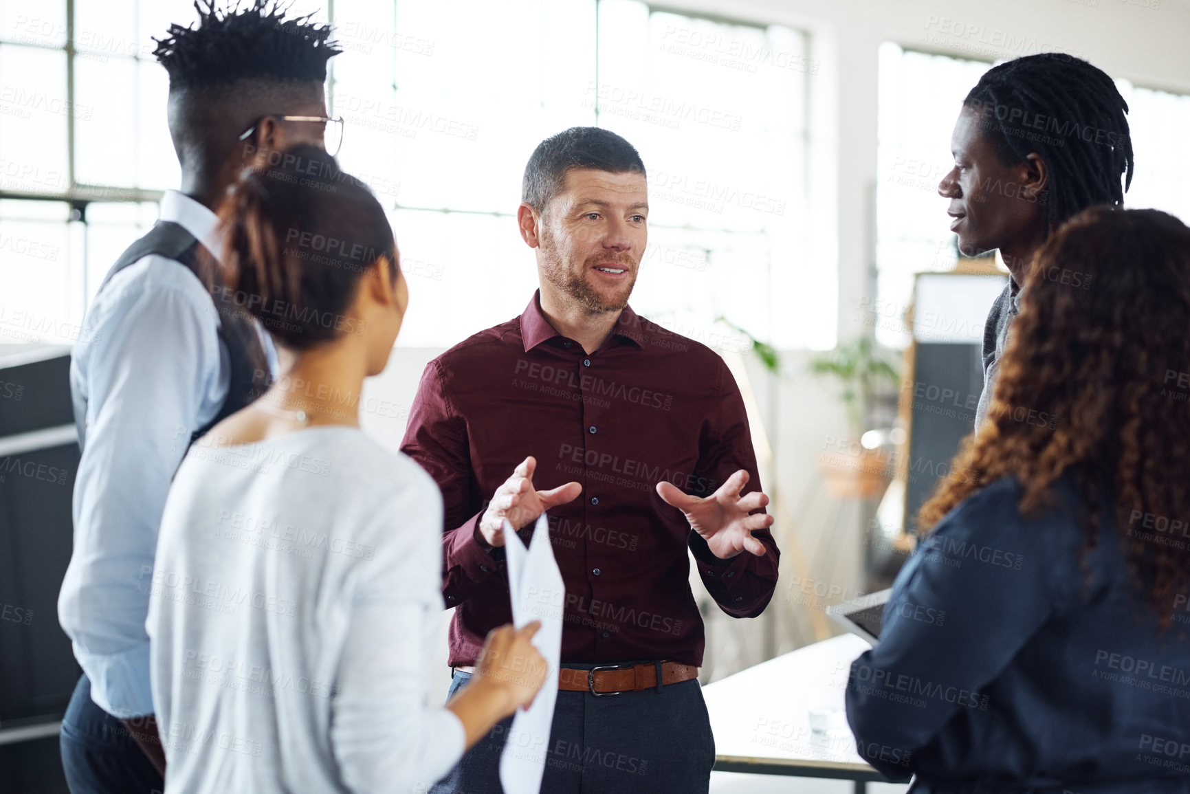 Buy stock photo Shot of a group of businesspeople having a discussion in an office