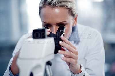 Buy stock photo Shot of a mature scientist using a microscope in her lab