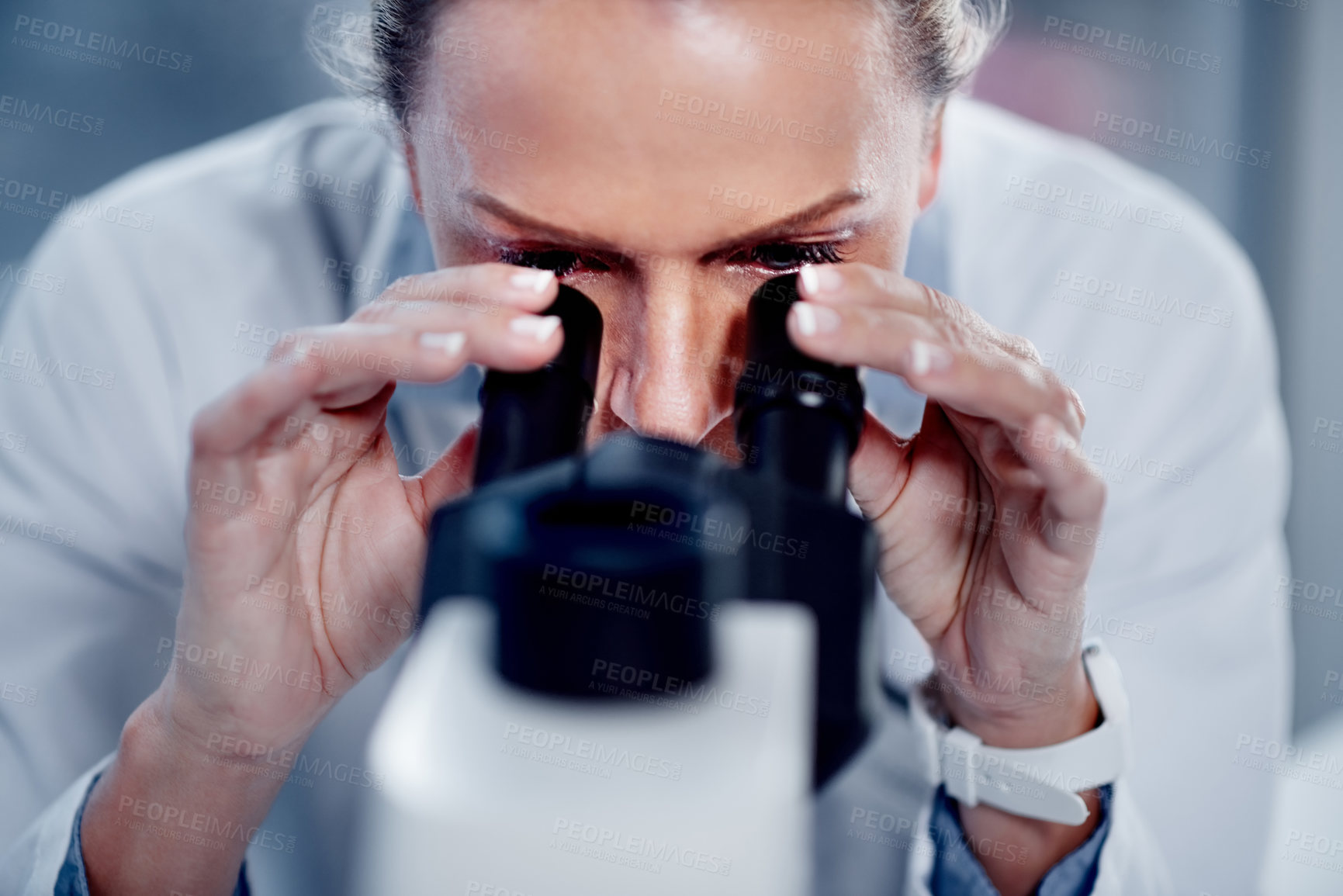 Buy stock photo Shot of a mature scientist using a microscope in her lab