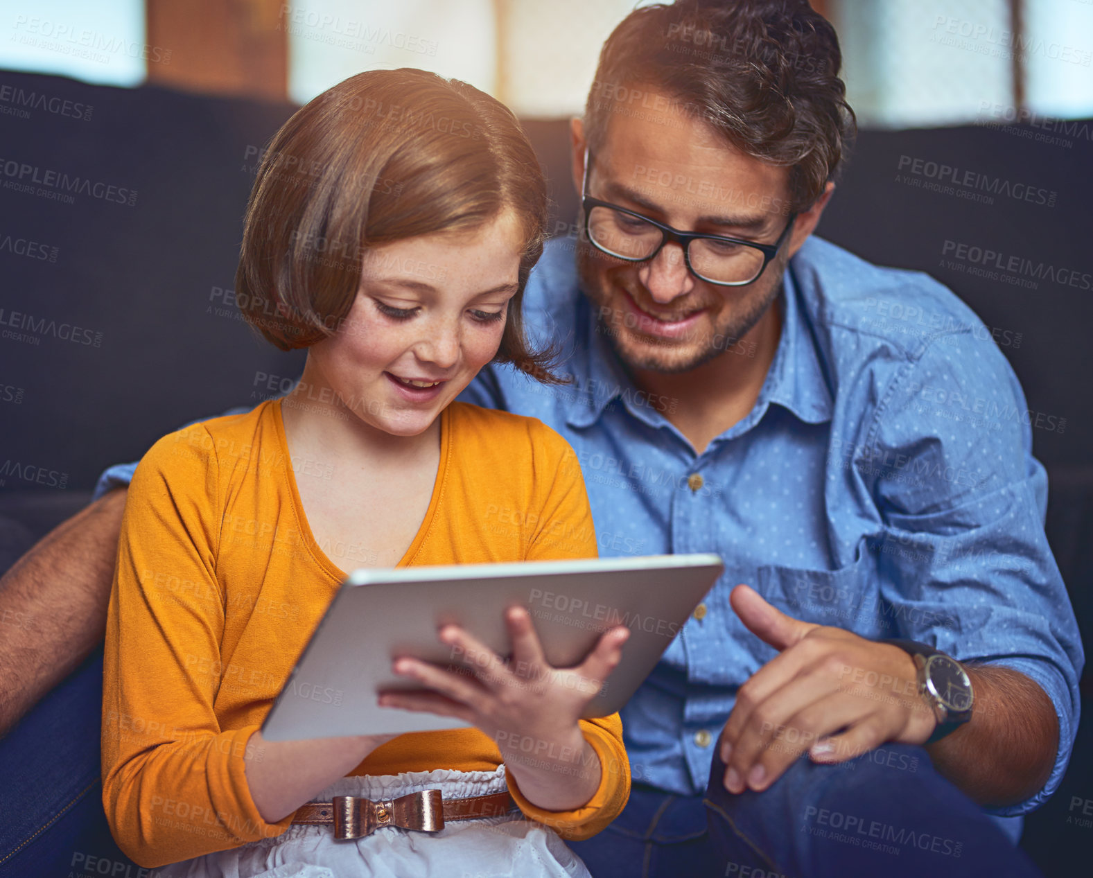 Buy stock photo Man, smile and kid with tablet on sofa for internet website, connection and watching movie together. Happy, father and daughter with technology at home for funny film, online and streaming service