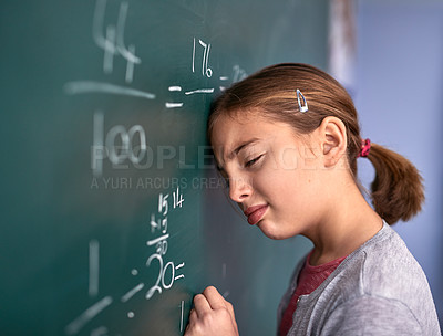 Buy stock photo Cropped shot of an elementary school girl pressing her head against the blackboard with frustration in class