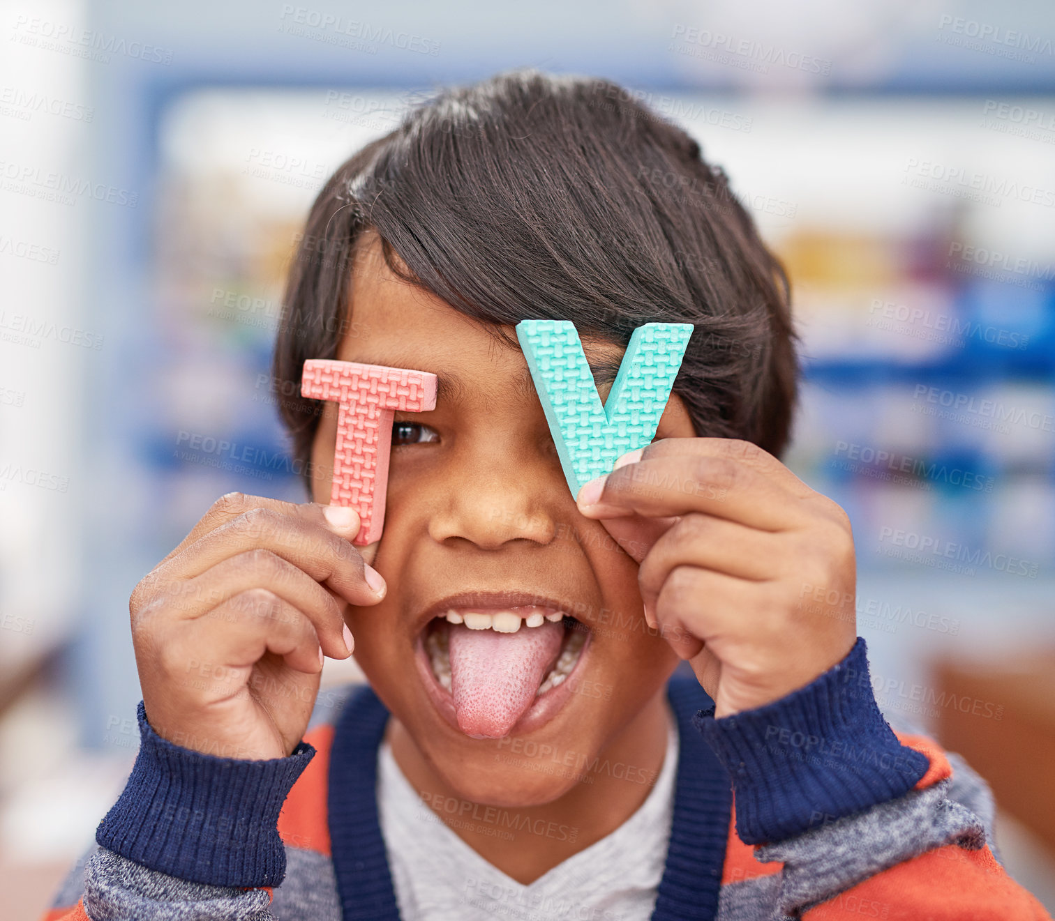 Buy stock photo Letters, portrait or happy child in classroom for playing, toys or alphabets with smile or student. Boy, primary school and face of playful young kid for tv words, development or education in India