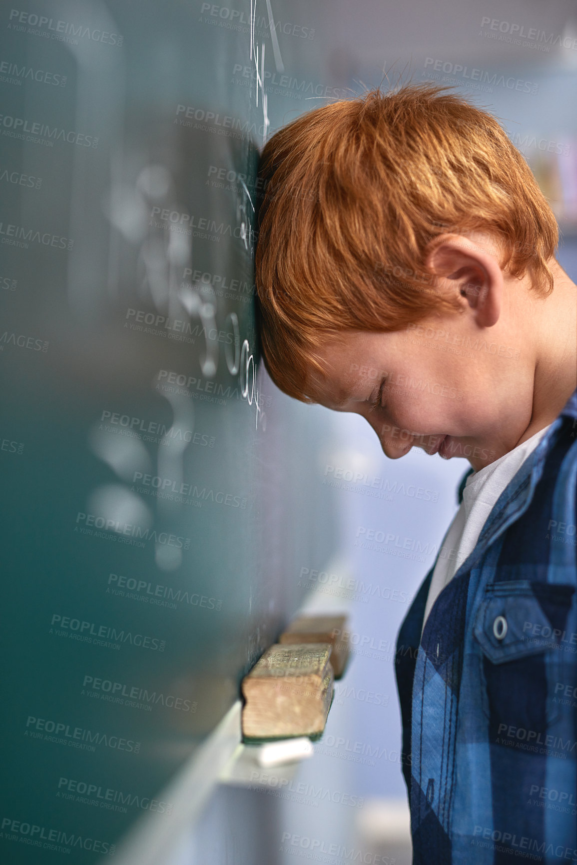 Buy stock photo Cropped shot of an elementary school boy pressing his head against the blackboard with frustration in class