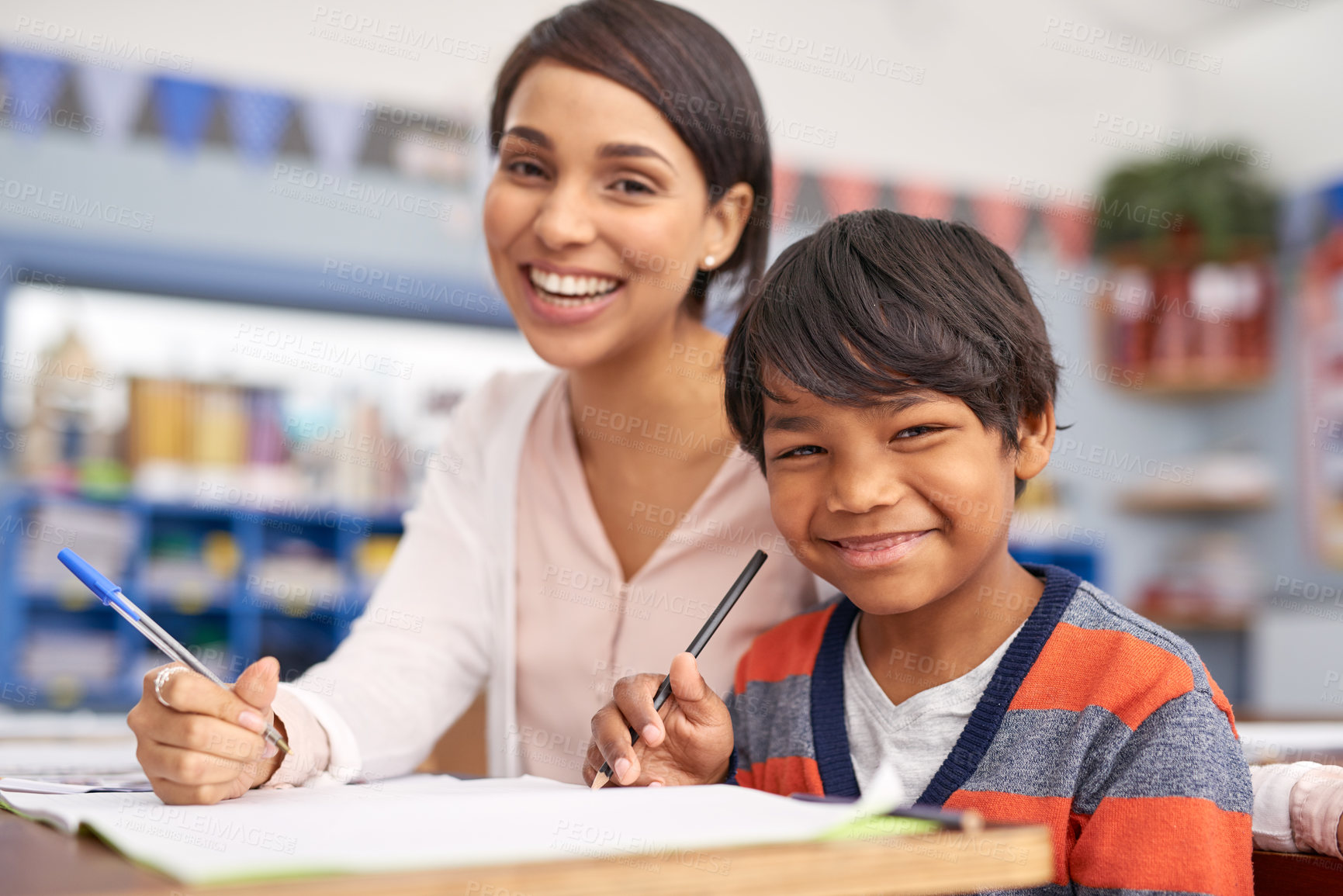 Buy stock photo Cropped shot of a teacher helping an elementary school child in class