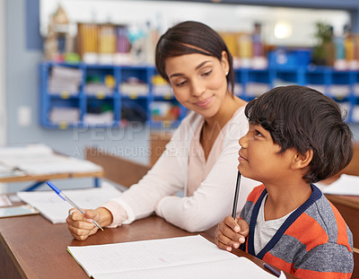 Buy stock photo Cropped shot of a teacher helping an elementary school child in class