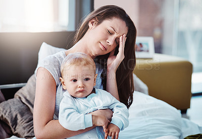 Buy stock photo Stress, headache and a a mother with her baby in a bedroom of their home together in the morning. Children, family and burnout with a tired mama sitting on a bed with an infant son as a single parent