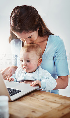Buy stock photo Mom, baby and desk with laptop in house for child development, video and mothers day with kiss on head. Woman, kid and table with technology in home for learning, entertainment and growth with
