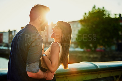 Buy stock photo Cropped shot of an affectionate young couple laughing while on a date