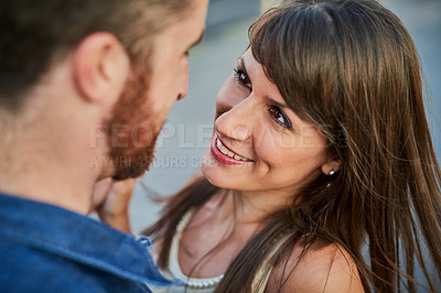 Buy stock photo High angle shot of an affectionate young couple looking lovingly into one another's eyes while on a date