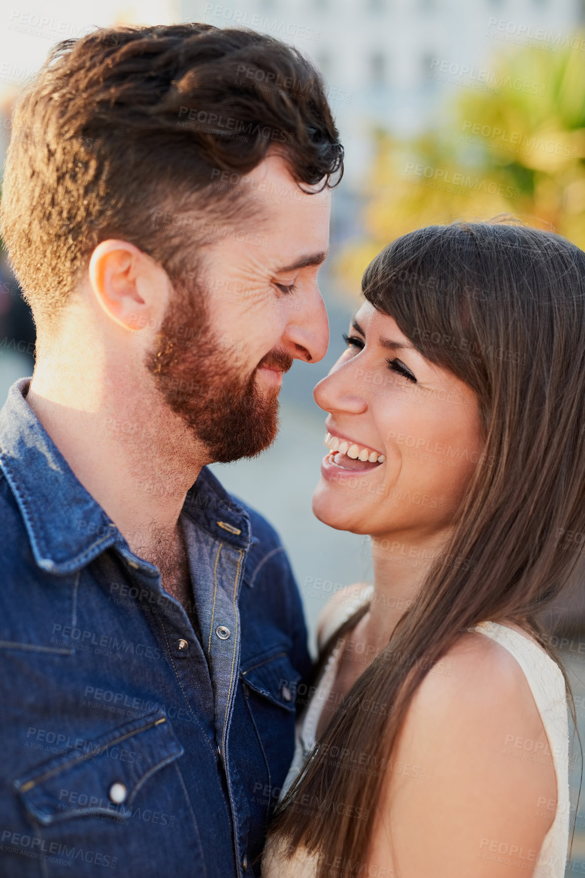 Buy stock photo Happy, couple and affection with love in city for romantic outdoor date, weekend and vacation together. Man, woman and hug in romance with connection at sunset for holiday adventure, marriage or care