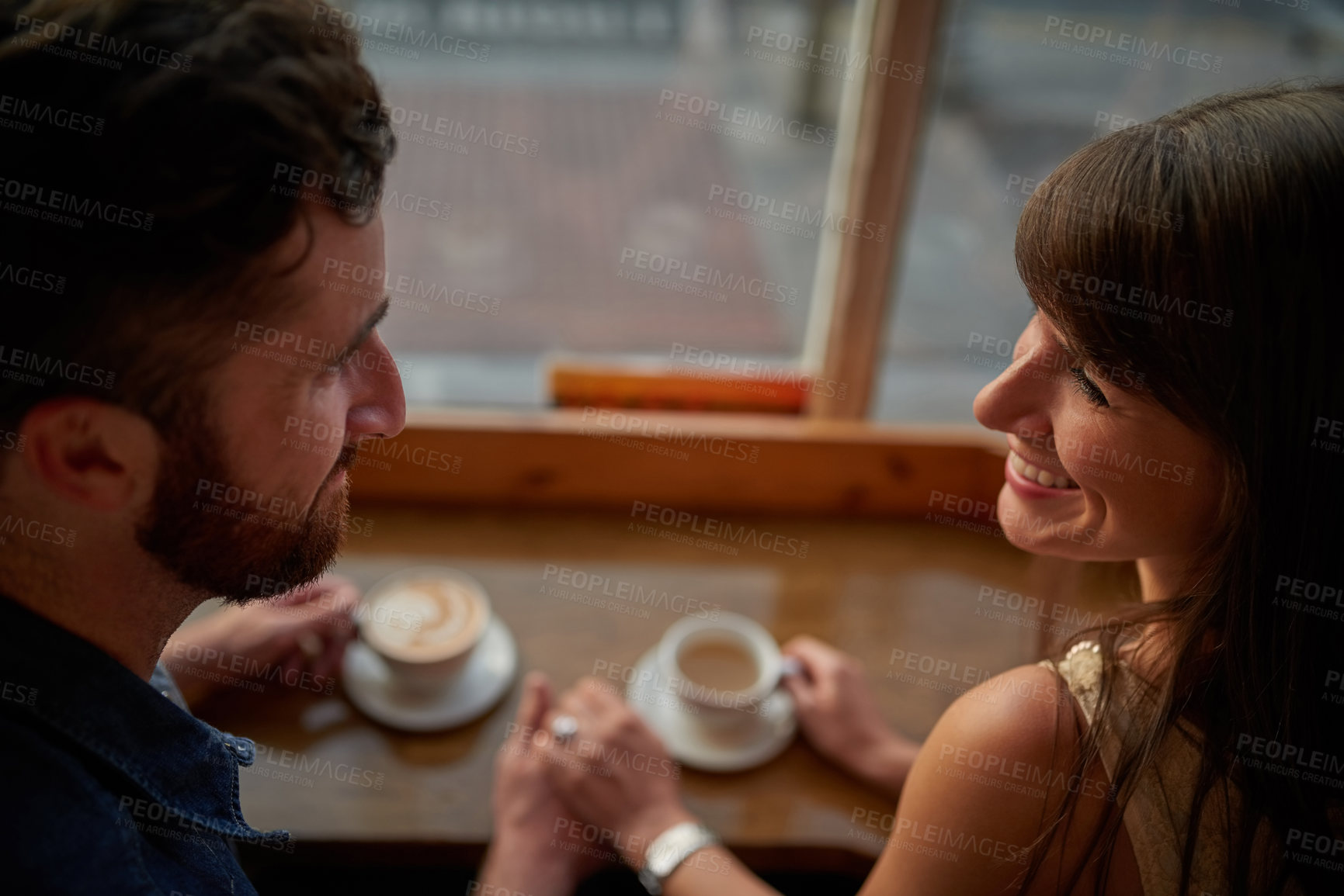 Buy stock photo Coffee shop, happy and couple holding hands with drink, caffeine beverage and cappuccino in cafe. Dating, love and man and woman relax in restaurant for bonding, relationship and romance on weekend