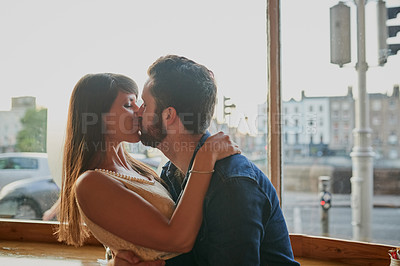 Buy stock photo Hug, couple and kiss in cafe for love, care and connection together for relationship on date. Romance, man and woman embrace in coffee shop for commitment, support or loyalty to partner on valentines