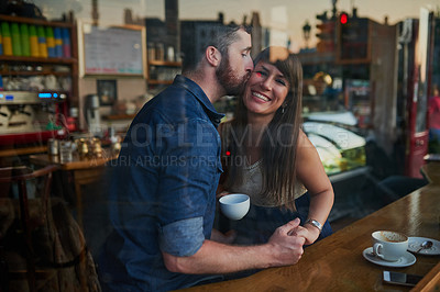 Buy stock photo Coffee shop, kiss and portrait of couple holding hands with drink, caffeine beverage and cappuccino in cafe. Dating, love and man and woman relax in restaurant for bonding, relationship and romance