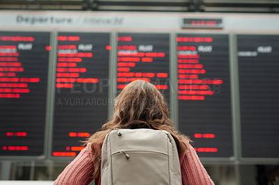 Buy stock photo Rearview shot of an unrecognizable young woman standing in an airport