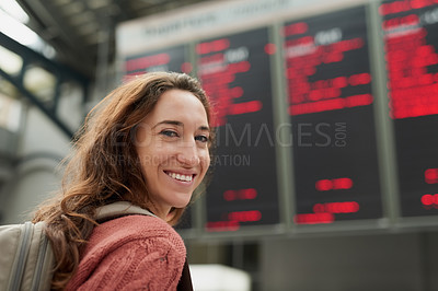 Buy stock photo Rearview portrait of an attractive young woman standing in an airport