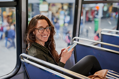 Buy stock photo High angle portrait of an attractive young woman listening to music while sitting on a bus