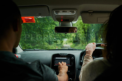 Buy stock photo Rearview shot of a young couple sitting in their car ready to depart on their roadtrip