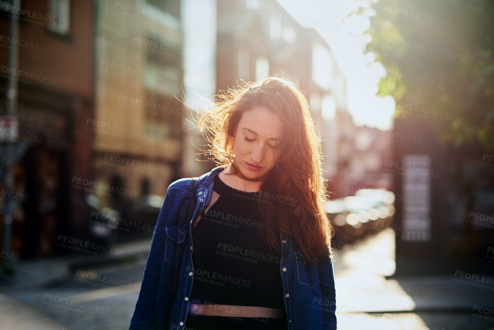 Buy stock photo Cropped shot of an attractive young woman walking through the city