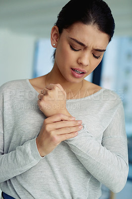 Buy stock photo Shot of a young businesswoman suffering with pain in her hands