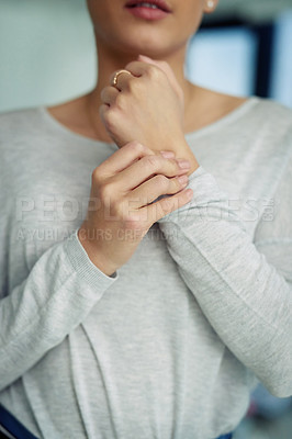 Buy stock photo Closeup shot of an unidentifiable businesswoman suffering with pain in her hands