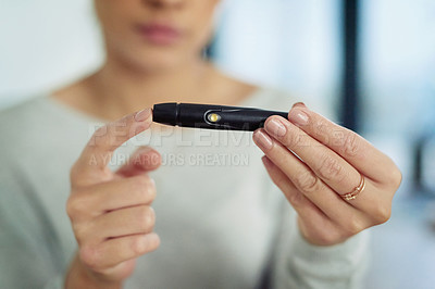 Buy stock photo Closeup shot of an unidentifiable woman testing her sugar level