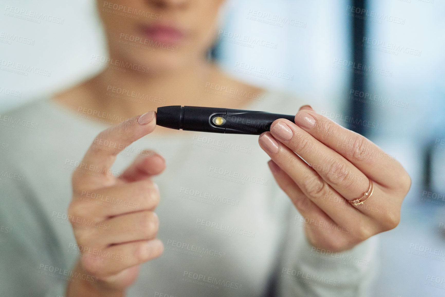 Buy stock photo Closeup shot of an unidentifiable woman testing her sugar level