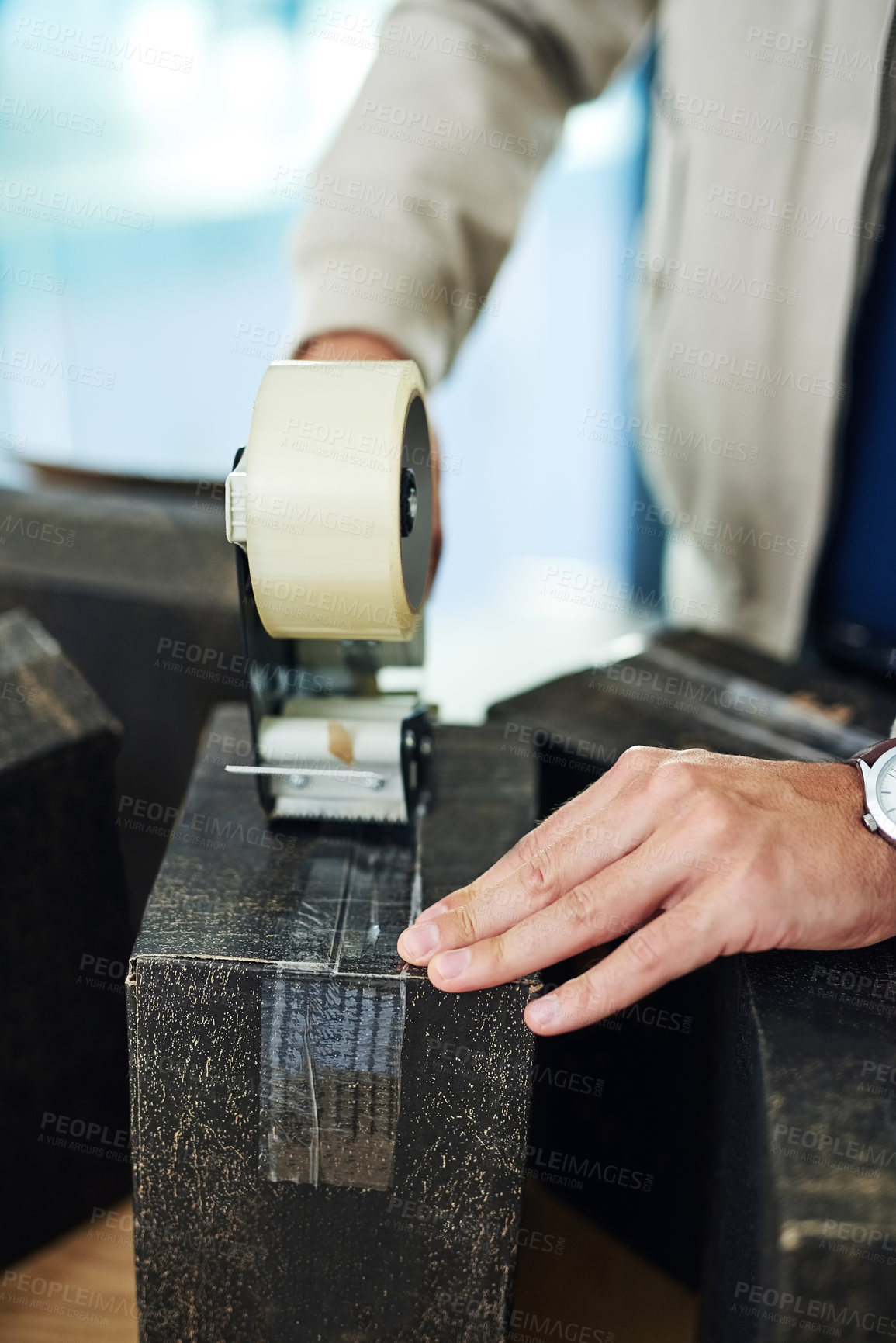 Buy stock photo Closeup shot of a delivery man sealing a box with tape