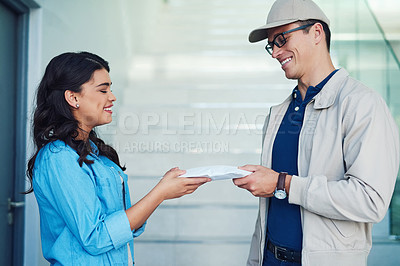Buy stock photo Shot of a courier making a delivery to a customer