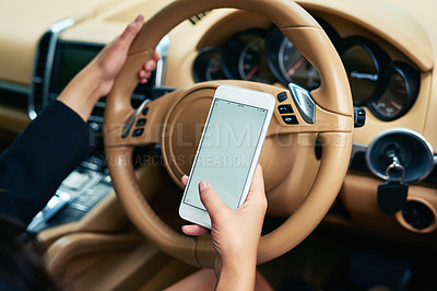 Buy stock photo Shot of an unrecognizable woman using a cellphone while driving