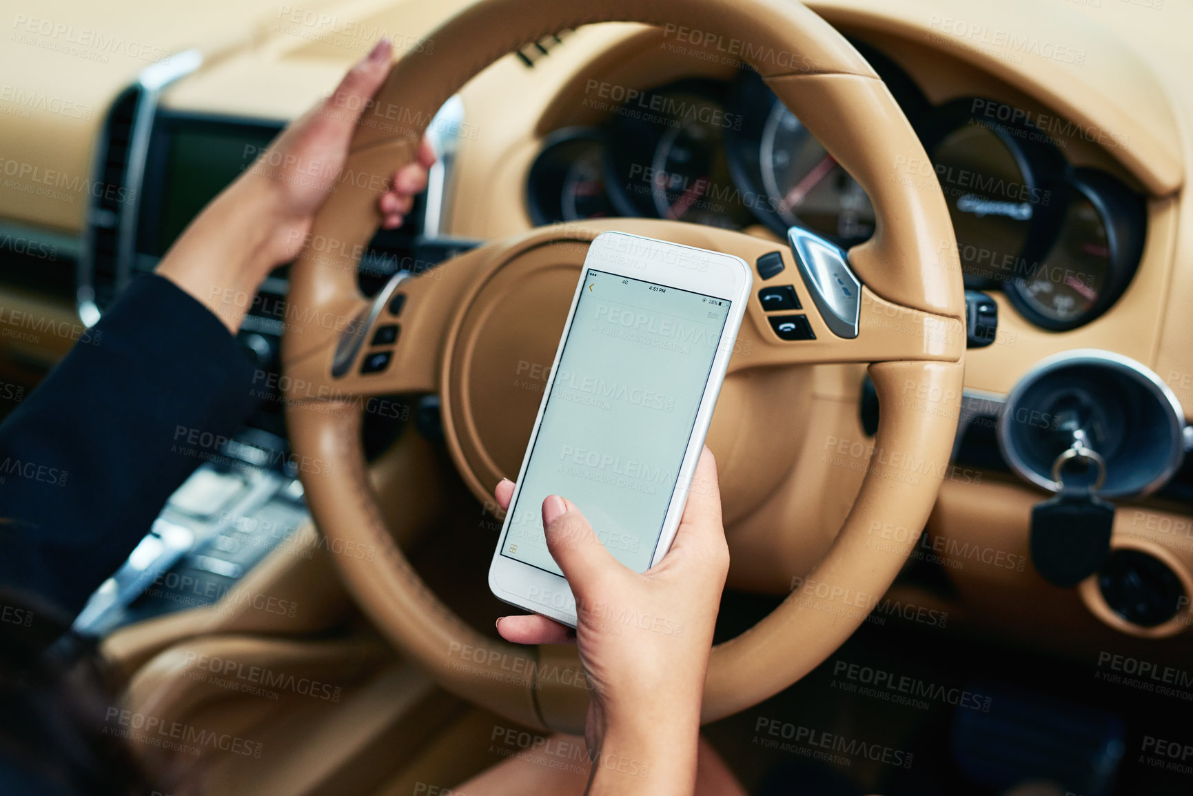 Buy stock photo Shot of an unrecognizable woman using a cellphone while driving