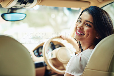 Buy stock photo Shot of an attractive young woman driving a car