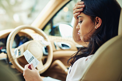 Buy stock photo Shot of an attractive young woman annoyed that she got a traffic ticket