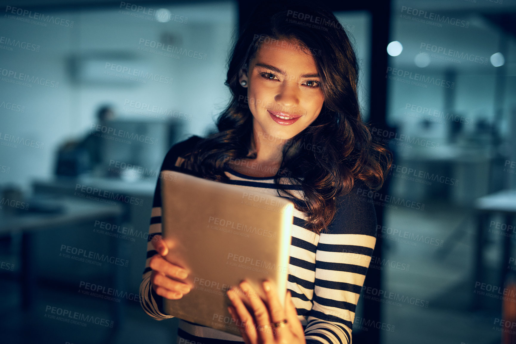 Buy stock photo Portrait of a young businesswoman working late on a digital tablet in an office