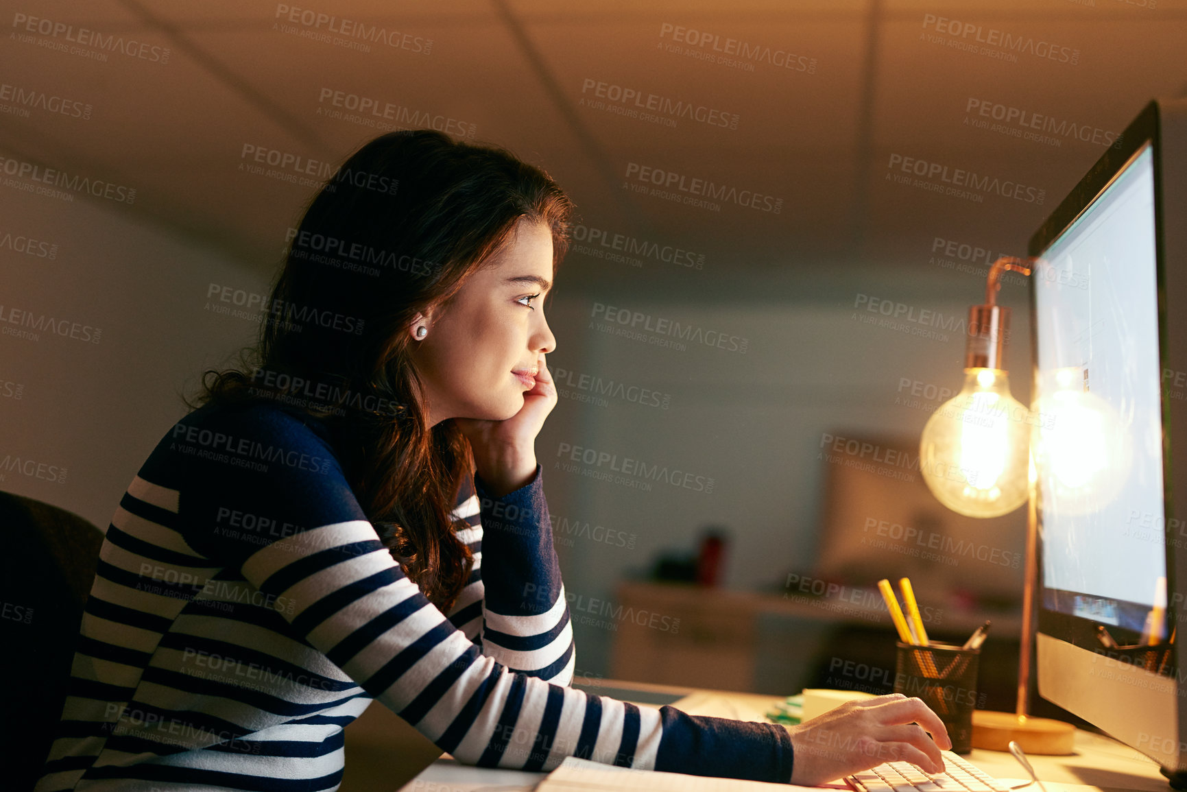 Buy stock photo Computer, design and night with happy woman in office for creative web development or evening research. Business, programming on desktop and smile with employee in workplace for project deadline