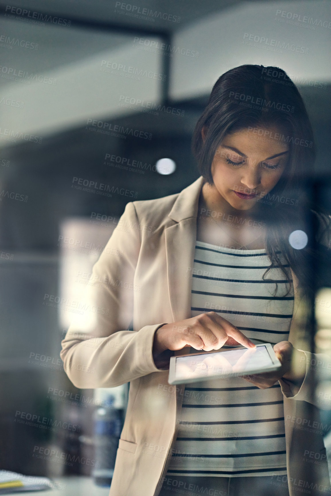 Buy stock photo Woman, tablet and night for reporting in office, global communication and project management. Female person, journalist and online to upload article in workplace, deadline and website for overtime