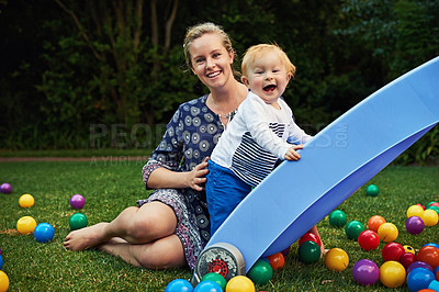 Buy stock photo Shot of an adorable little boy and his mother playing in the backyard