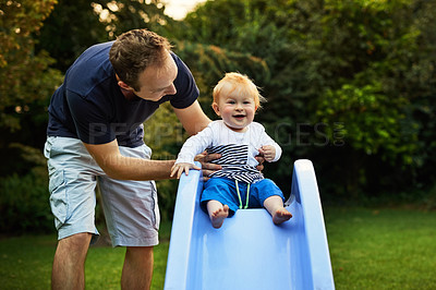 Buy stock photo Shot of an adorable little boy and his father playing in the backyard