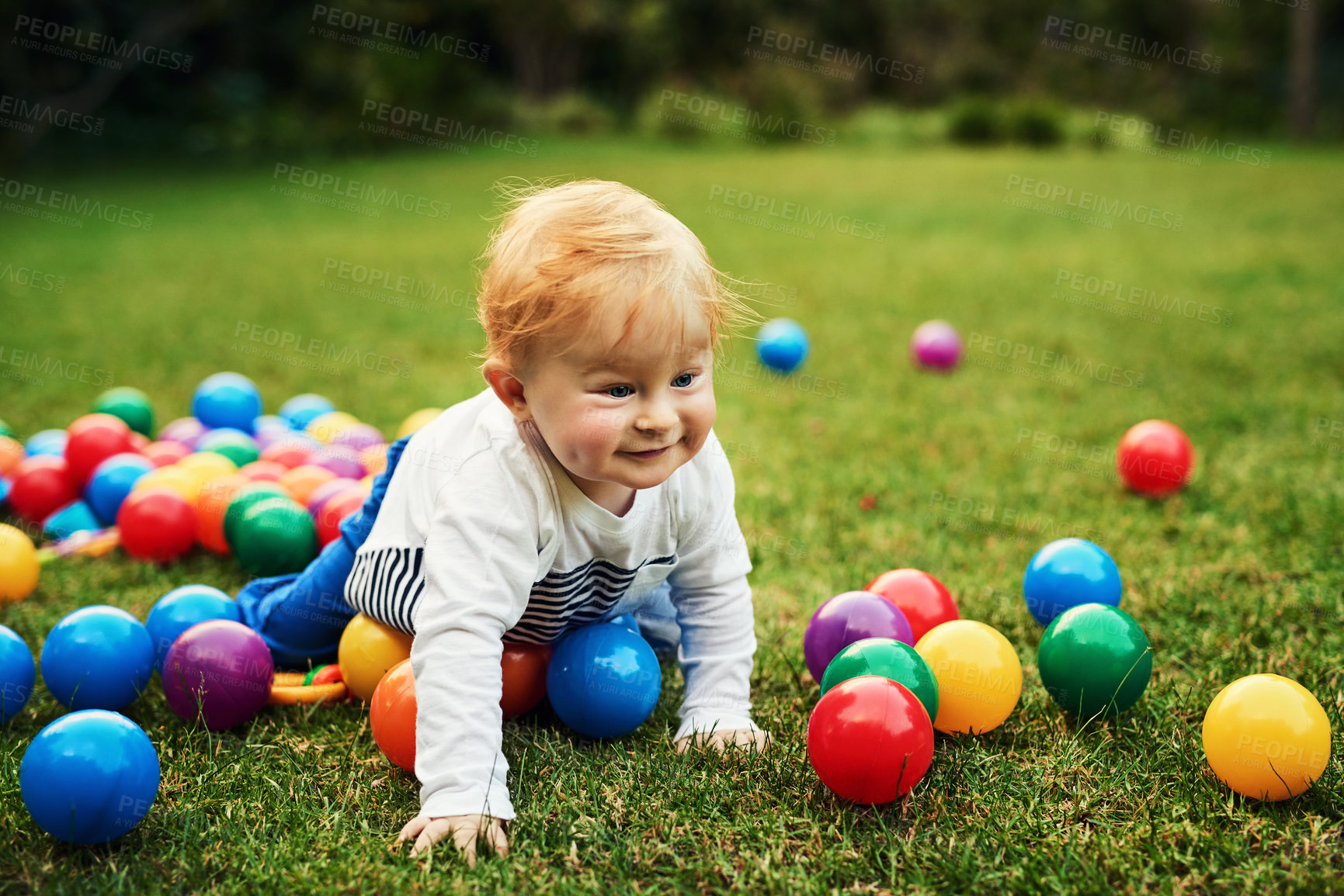 Buy stock photo Baby, grass and playing with balls outdoor in park or backyard for motor skills and early childhood development. Happy child on floor crawling with colorful toys for holiday, fun and learning on lawn