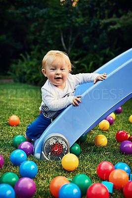 Buy stock photo Game, colourful balls and baby in backyard, relax and playful with fun, happiness and calm. Smile, infant and toddler on grass, cheerful and carefree with motor skills, kid and childhood with nature