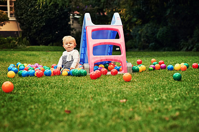 Buy stock photo Outdoor, ball and portrait of cute baby, playground and wellness with games, relax and young in space. Nature, growth and development for child, playing and learning of toddler and lawn of Ireland